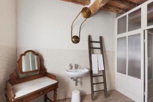 a bathroom with a sink and a mirror and a ladder at Corte Croce in Gonzaga