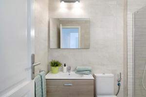 a bathroom with a sink and a toilet and a mirror at Apartamento Seaview Limones in Playa Blanca +24 photos