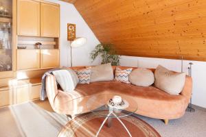a living room with a couch and a glass table at Ferienwohnung Birkenberger in Löffingen