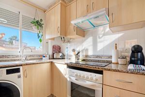 a kitchen with a sink and a dishwasher at Playa de Chilches in Chilches +13 photos