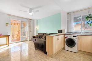 a living room with a couch and a washing machine at Playa de Chilches in Chilches