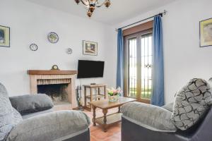 a living room with two couches and a fireplace at Casa Villanueva 2 - Sólo Familias in Conil de la Frontera
