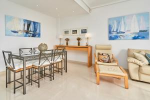 a living room with a table and chairs and a couch at Balcon Bella Vista in Nerja