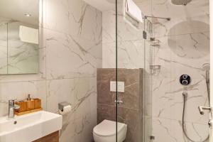 a bathroom with a shower and a toilet and a sink at Ferienwohnung Daniel in Ehrwald +11 photos