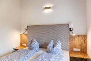 a bedroom with two beds with blue and white pillows at Ferienwohnung Daniel in Ehrwald