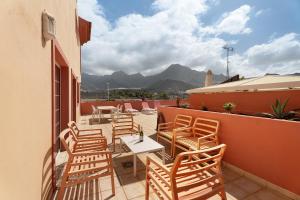 a patio with chairs and a table on a balcony at terrazas del duque fase2 in Adeje