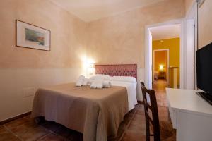 a hotel room with a bed with towels on it at Rosaspina - Appartamento 6 in Capalbio +22 photos
