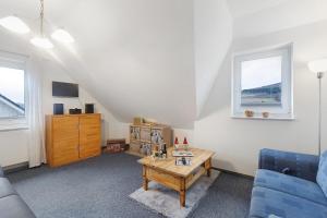 a living room with a couch and a table at Ferienwohnung Westfeld in Bestwig