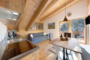 a kitchen and living room in a tiny house at Töniglerhof Apt Morgensonne in Trodena