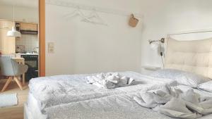 a bedroom with a bed with white sheets at Fewo Seehaase in Radolfzell am Bodensee