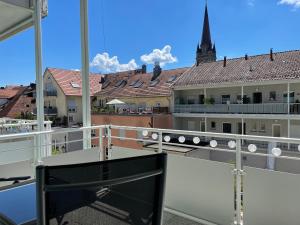 a balcony with a view of the roofs of buildings at Fewo Seehaase in Radolfzell am Bodensee