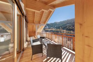 a balcony with chairs and a view of the mountains at Töniglerhof Apt Morgensonne in Trodena