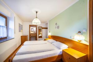 a bedroom with a large bed and two lamps at Wohnung Gravensteiner Schnalserhof in Laces