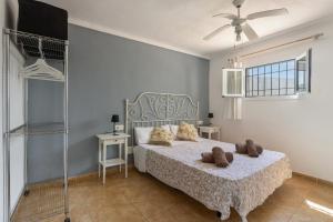 a bedroom with a bed and a ceiling fan at Finca Can Paci in Santa Eularia des Riu