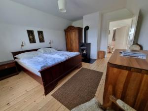 a bedroom with a large bed and a stove at Zankl in Lavamünd