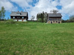 an old house and a barn in a field at Zankl in Lavamünd +2 photos