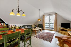 a living room with a table and a dining room at Haus Halligblick in Dagebüll