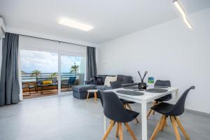 a living room with a table and chairs at First Line Mediterranean Apartment in Calvià