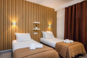 a hotel room with two beds in a room at First Line Mediterranean Apartment in Calvià