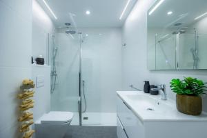a bathroom with a shower and a toilet and a sink at First Line Mediterranean Apartment in Calvià +19 photos