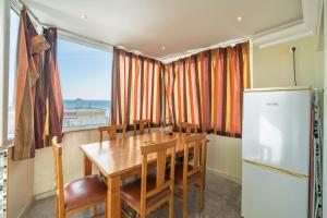 a kitchen with a wooden table and a refrigerator at Apartamento Belmar in Armação de Pêra +14 photos