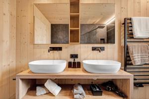 two white sinks on a wooden counter in a bathroom at Ratscheinerhof App Waldruhe in Lazfons +32 photos