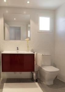 a bathroom with a toilet and a sink and a mirror at Con Encanto in Port de Soller +10 photos