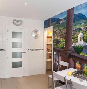 a dining room with a painting on the wall at Con Encanto in Port de Soller