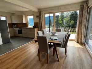 a kitchen and dining room with a table and chairs at Landhaus Steinrose in Bodensdorf