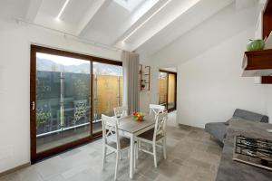 a kitchen and dining room with a table and chairs at Villa Degli Dei in Agerola