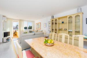 a living room with a table with a bowl of fruit on it at Apartment La Veleta with Sea View in El Port