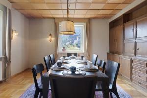 a dining room with a table and chairs and a window at Donau-One in Beuron
