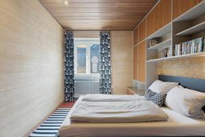 a bedroom with a large bed and a window at Donau-One in Beuron