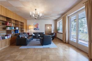 a living room with couches and a chandelier at Donau-One in Beuron
