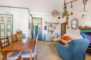 a living room with a table and a couch at La Rana Verde de Arriba in Los Romeros +20 photos