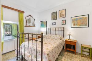 a bedroom with a bed and a table and a mirror at La Rana Verde de Arriba in Los Romeros