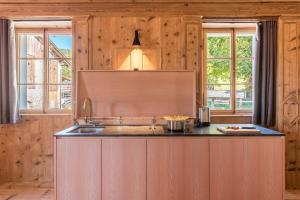 a kitchen with a sink and two windows at Hof im Thal Apt Zirbe in Aldino +21 photos