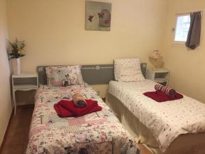 a bedroom with two beds with red towels on them at Gite Le Lot in Bias +7 photos