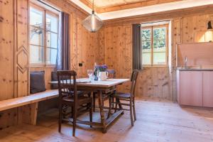 a wooden dining room with a table and chairs at Hof im Thal Apt Zirbe in Aldino