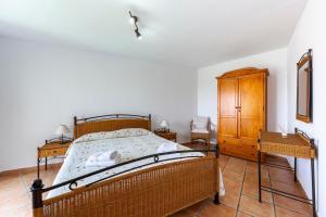 a bedroom with a bed and a wooden cabinet at Vista al Mar Ainara in Almería +16 photos
