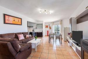 a living room with a couch and a table at Vista al Mar Ainara in Almería