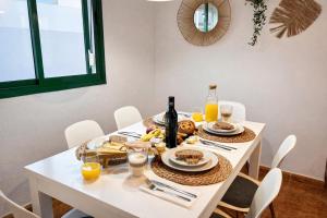 a white table with food and drinks on it at Kalendra Jable in Guatiza