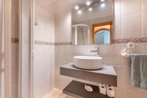 a bathroom with a sink and a mirror at Lago y Playa in Port d'Alcudia +17 photos