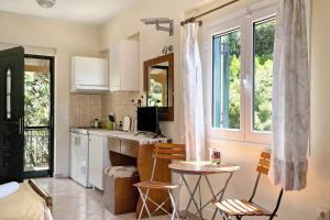 a kitchen with two chairs and a table in it at Vardia studio B in Mikros Gialos