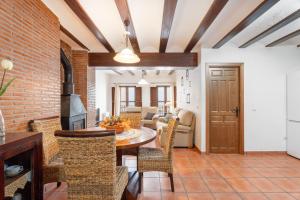 a kitchen and dining room with a brick wall at Cueva Del Gollisno in Chulilla