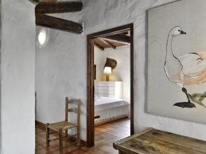 a bedroom with a bed and a chair and a mirror at Finca Fiori 1 in Is Molas 