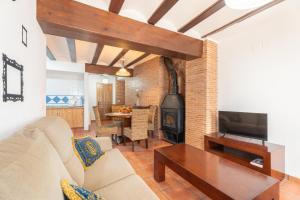 a living room with a couch and a fireplace at Cueva Del Gollisno in Chulilla