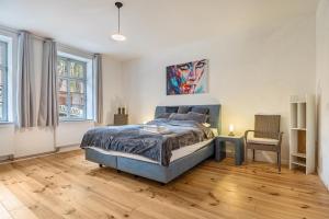 a bedroom with a bed and a chair at Suite mit Wintergarten in Dedelstorf