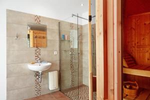 a bathroom with a sink and a shower at Ferienhaus Engert mit Holzofensauna in Althüttendorf +17 photos