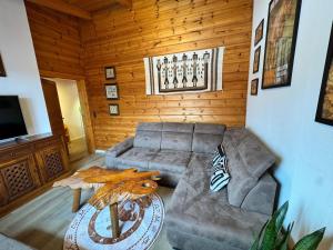 a living room with a couch and a table at Tiny Rooster Lodge in Alt Duvenstedt